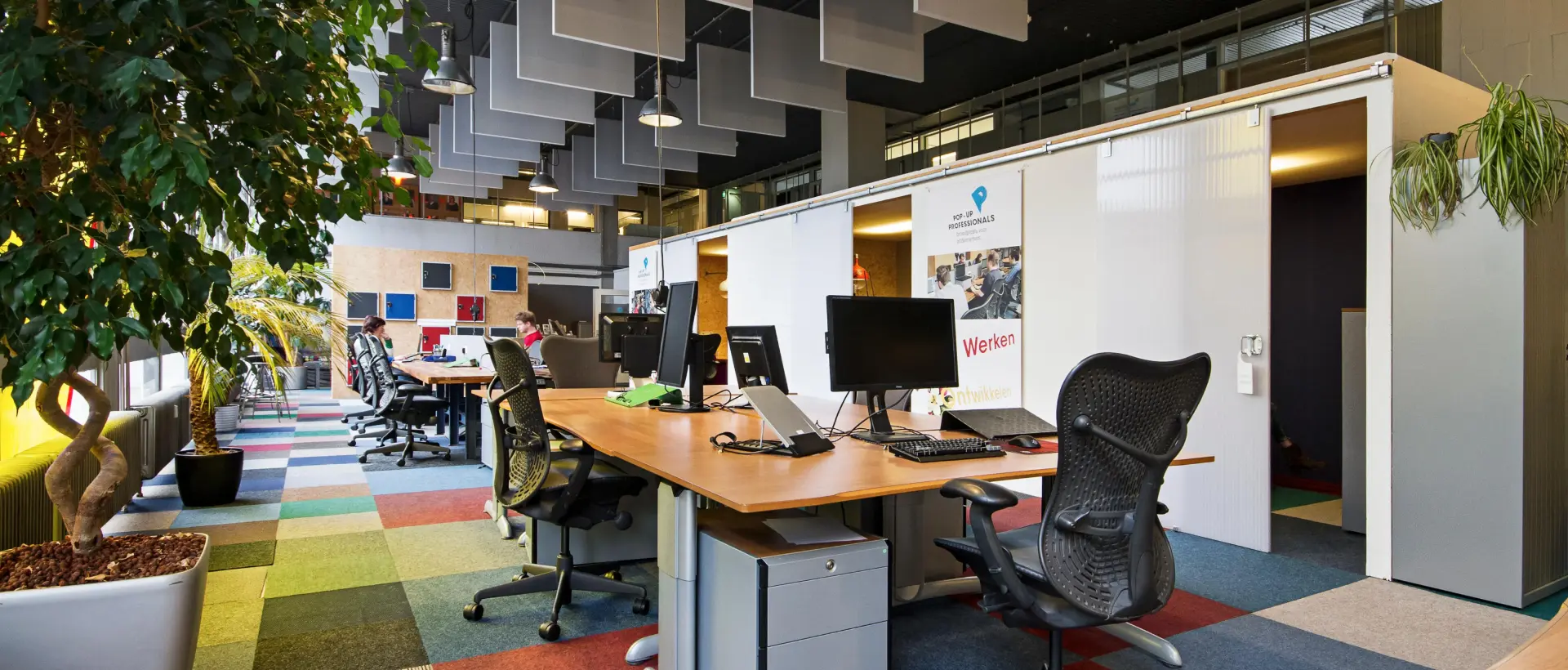 A professional meeting scene with diverse team members discussing business strategies in a modern office.